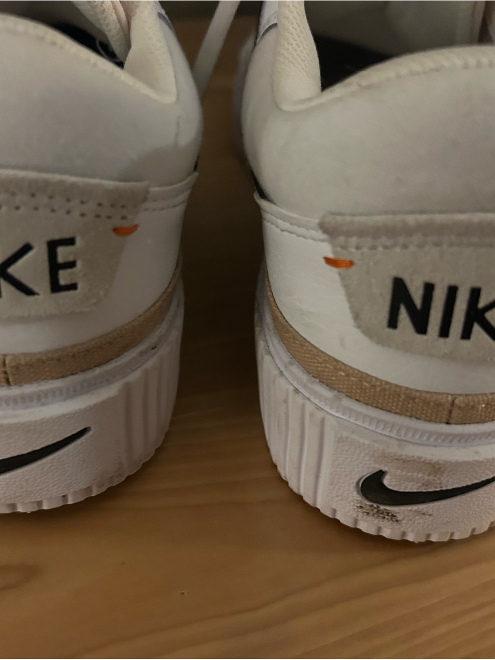 Nike White Low-Top Sneakers with Tan Heel Band and Orange Stitch Detail